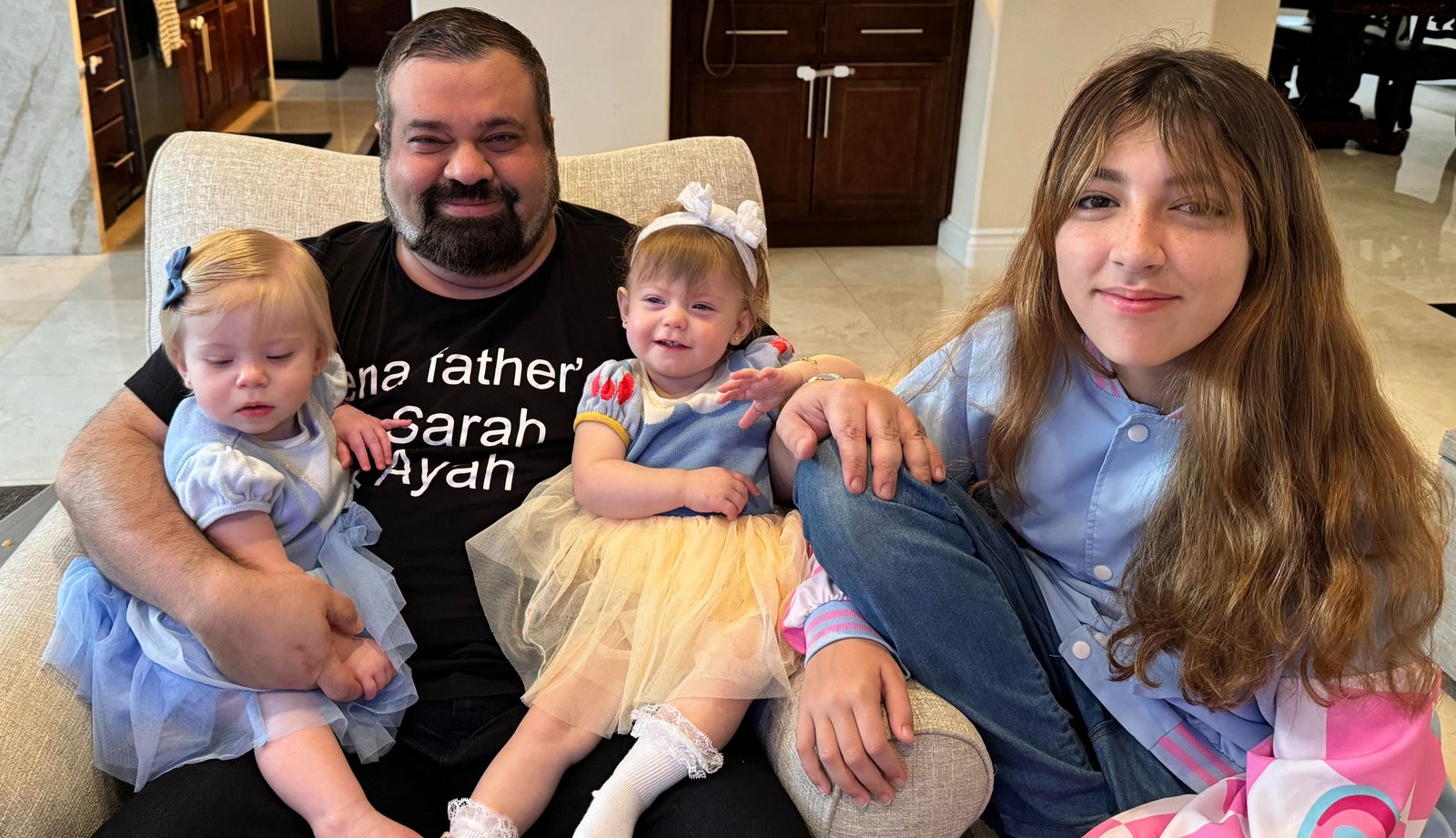 Sam Sammane with his three daughters