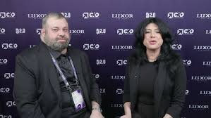 Sam Sammane interviewed in front of a CXO 2.0 Conference and LUXOR backdrop